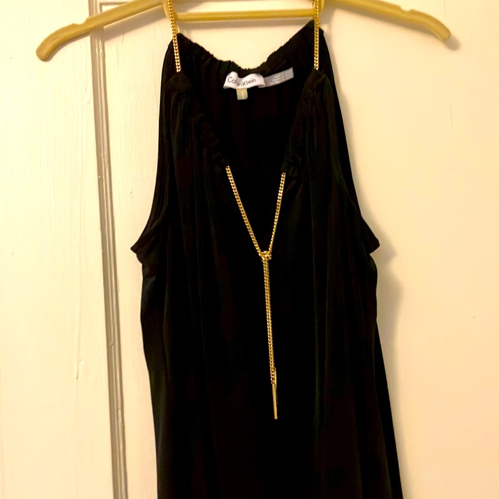 Calvin Klein sleeveless blouse with gold tie.